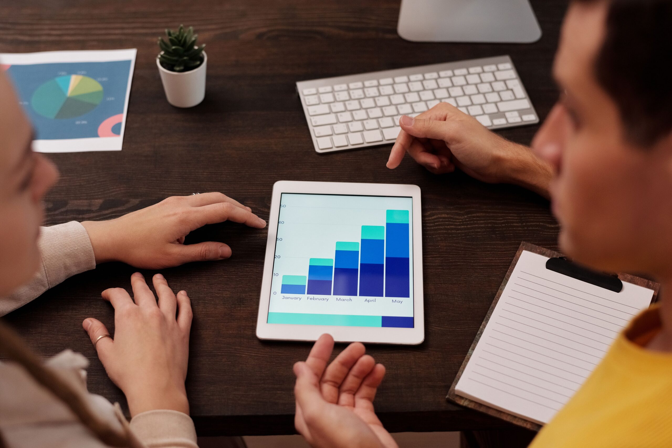 Marketing team reviewing lead generation growth and campaign performance on a digital dashboard.