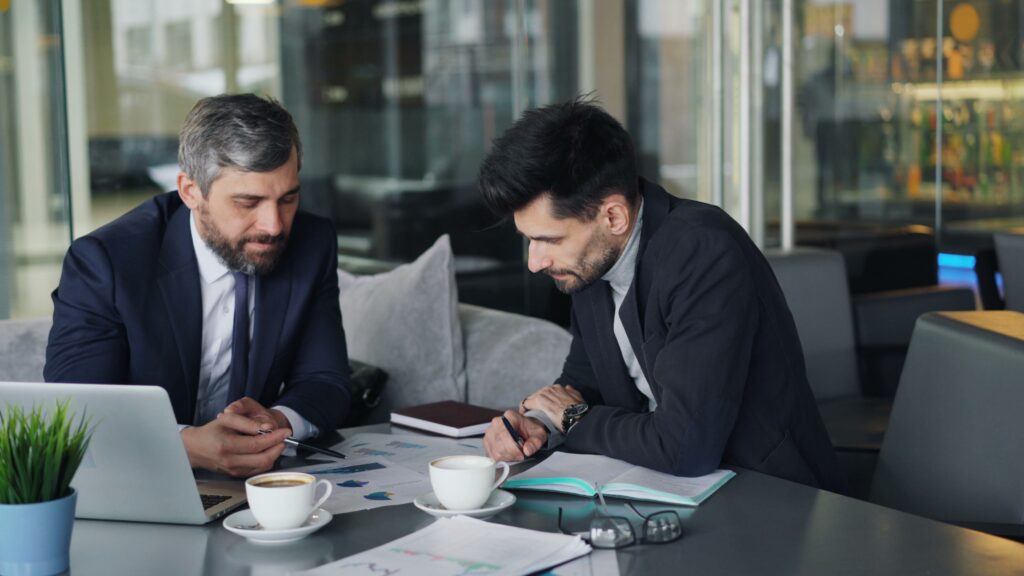 Criminal defense attorneys analyzing marketing data, advertising costs, and lead generation results.