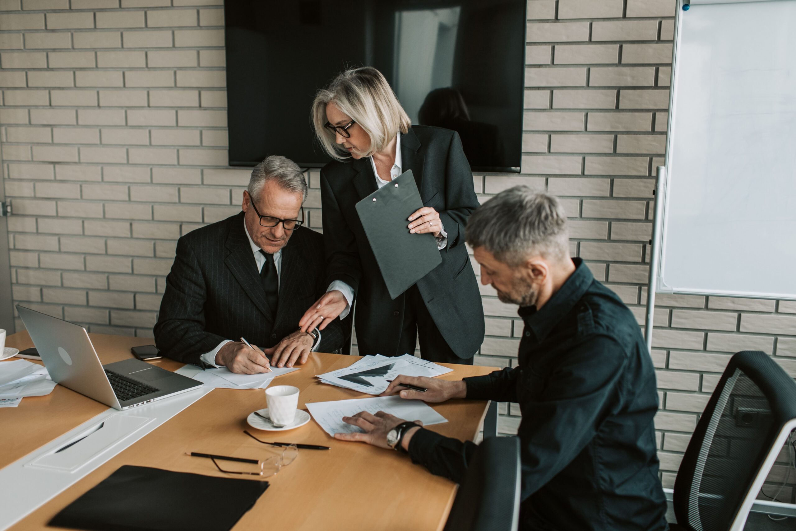 Business professionals reviewing documents before selecting a legal marketing agency.